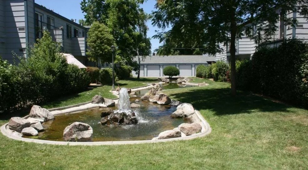 Koi pond with fountain (garage unit pictured in background) - 445 Almond Dr. #29