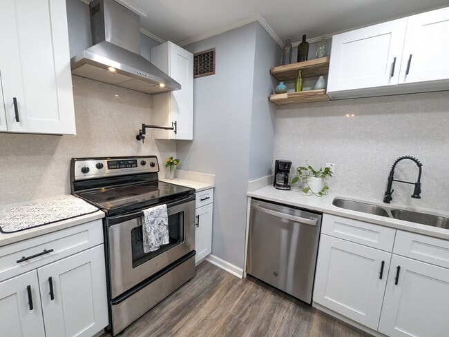 The kitchen has been recently renovated with modern amenities, stainless appliances, a dishwasher, l - 4107 Crane St