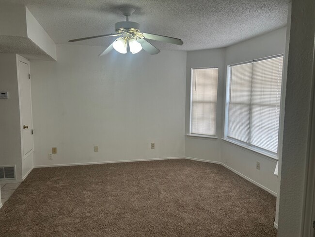 Living room with ceiling fan new carpet and paint - 1345 Trudy Elaine Dr