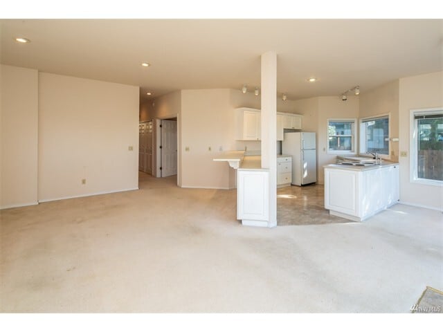 Looking back from the family room toward the kitchen and dining area, with the hallway beyond. - 2809 Eldridge Avenue