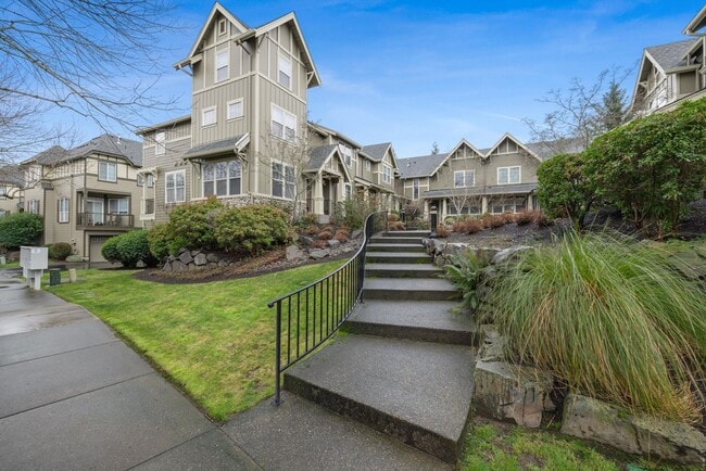 Building Photo - Lovely and bright townhouse with a hard wood flooring throughout, a 2 car garage, AC & more!