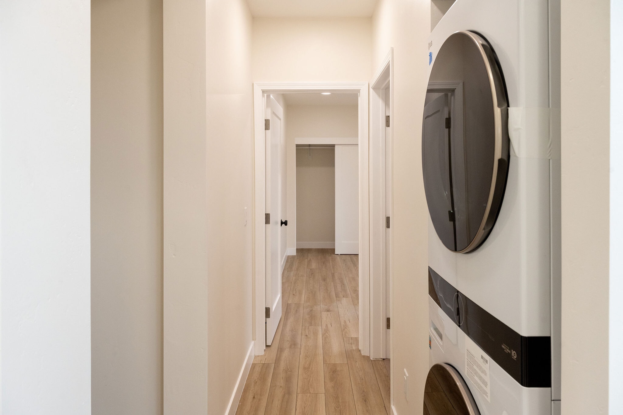 View walking down the hallway, private laundry to right and storage on left - 4772 Bancroft St