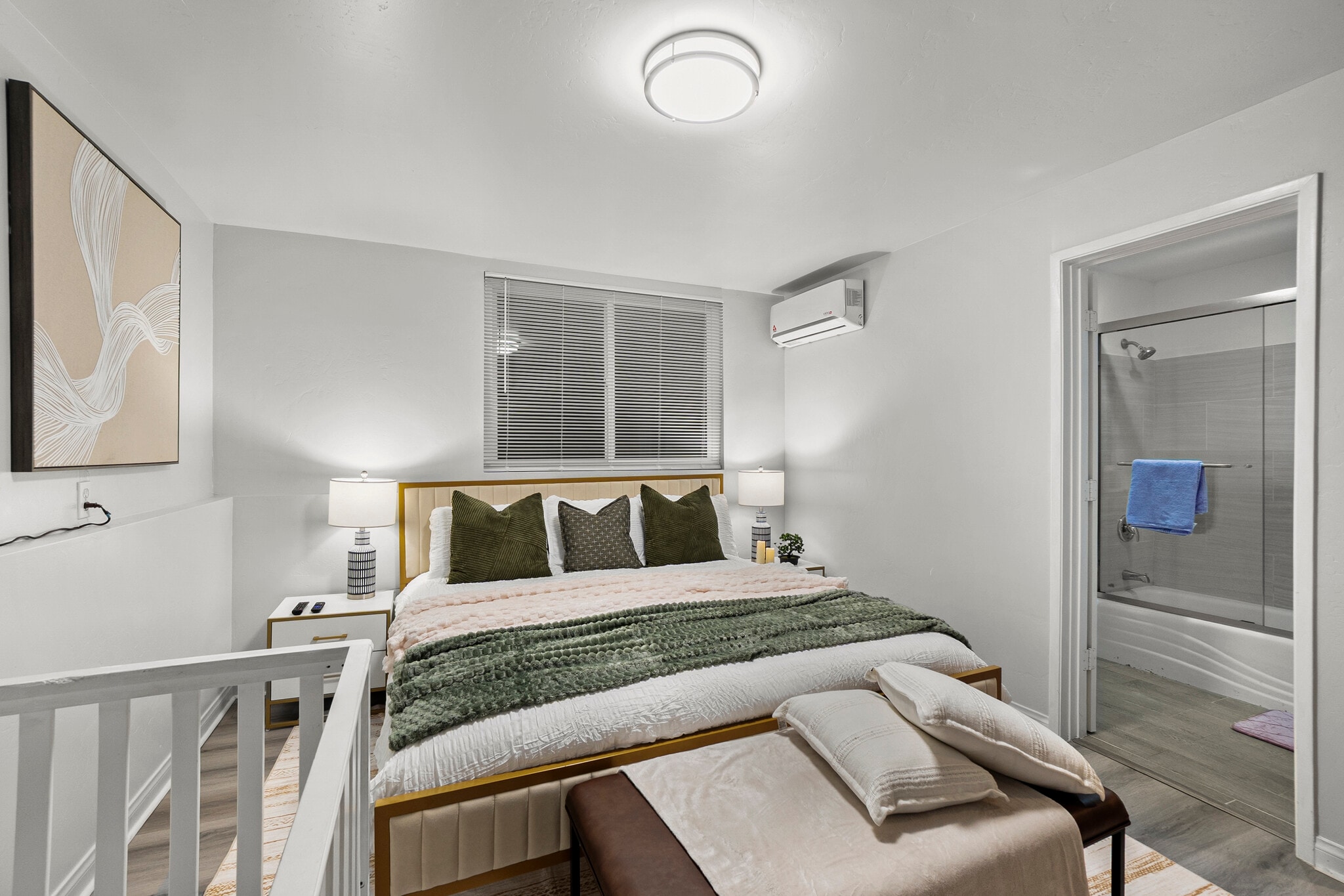 A cozy bedroom with a private en suite bathroom, offering comfort and convenience. - 4989 Randlett Dr