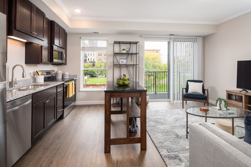 View of kitchen and living room area looking onto the balcony at The Whitley. - The Whitley