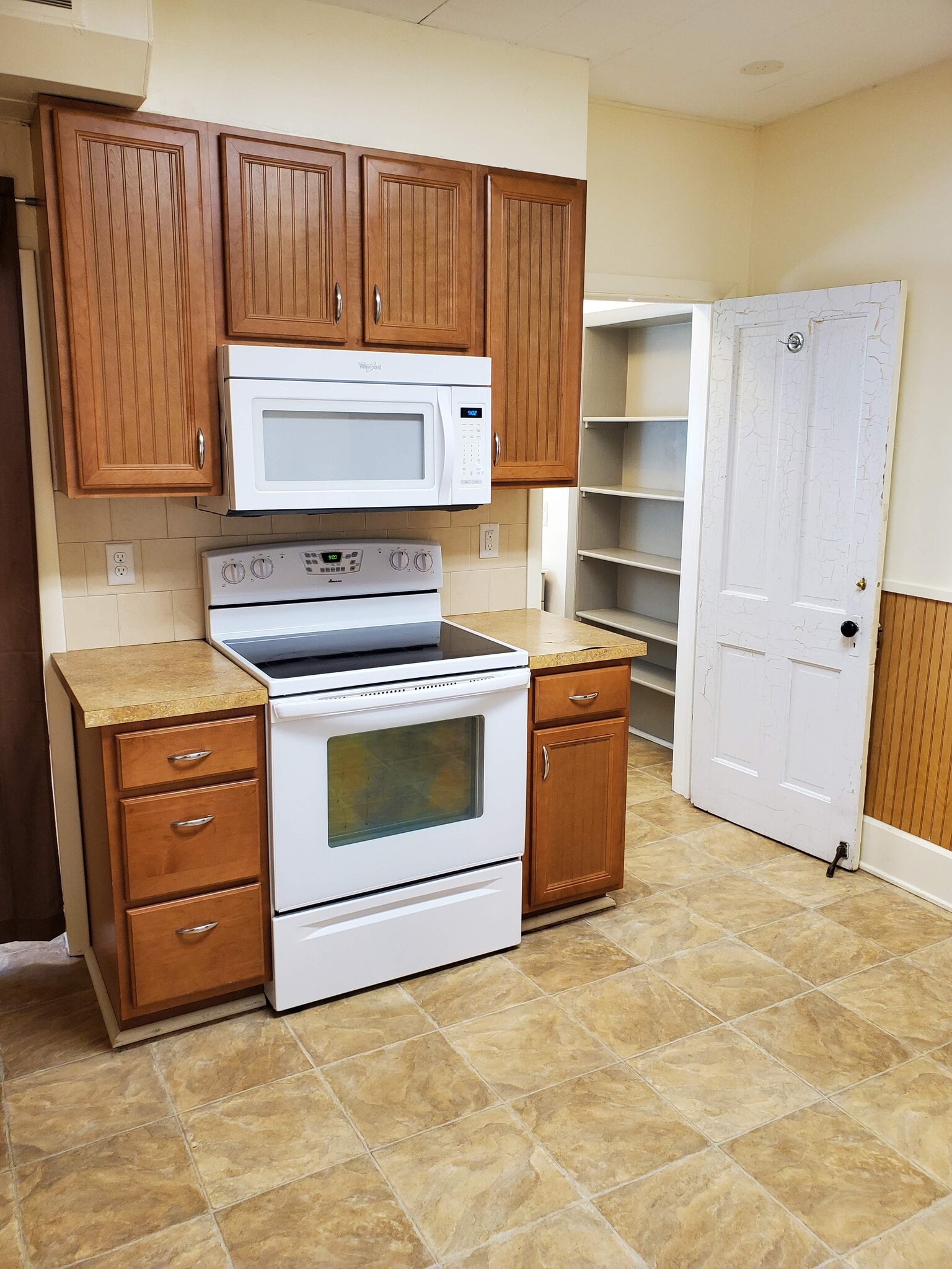 View of kitchen from laundry area. White door leads to bathroom - 607 Harrison Ave