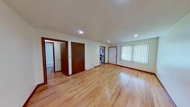 Building Photo - Updated two bedroom duplex, new stainless steel appliances, garage, and hardwood floors