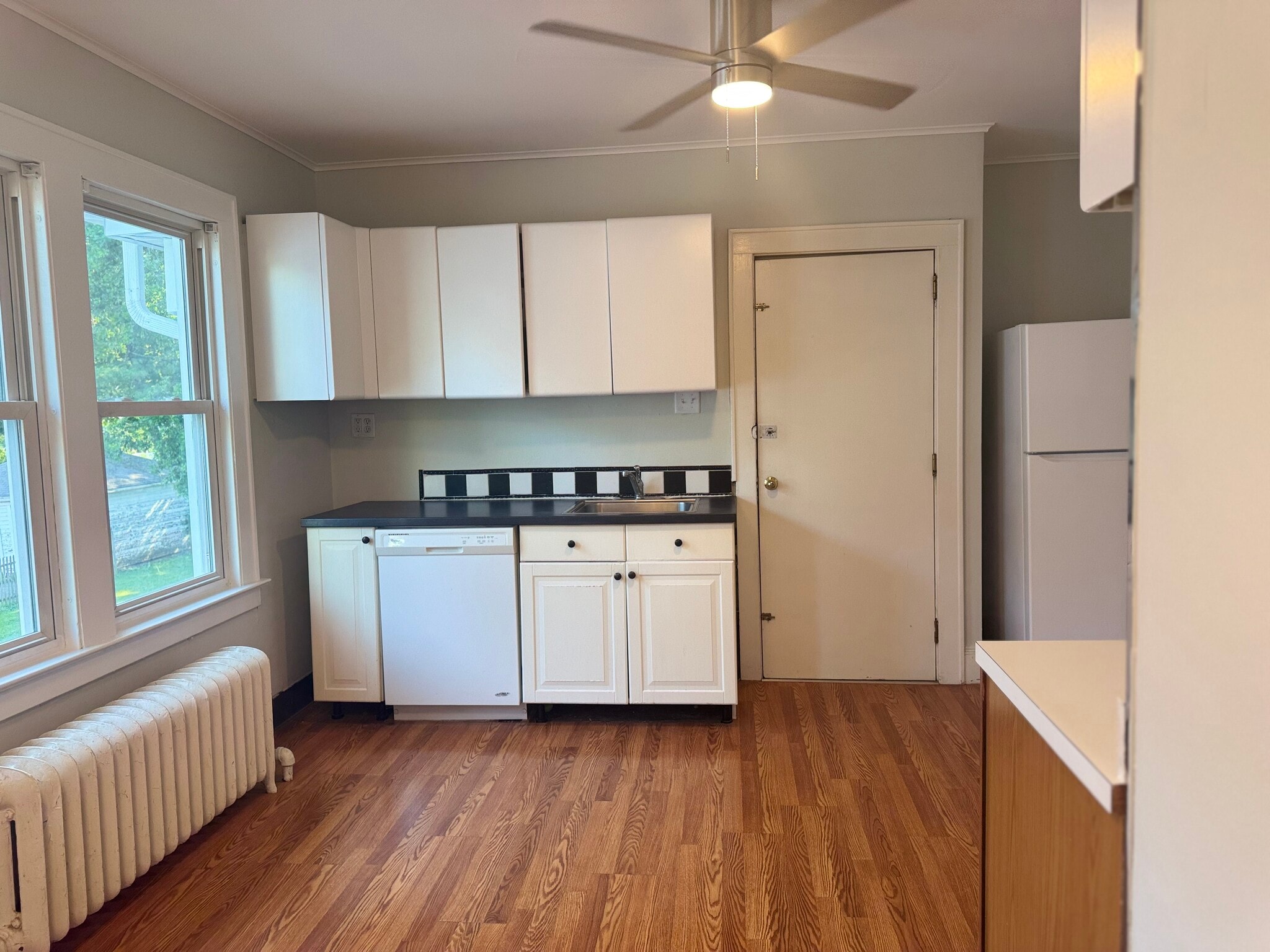 Past the swinging door, you will enter a spacious eat in kitchen - 135 Dover Rd