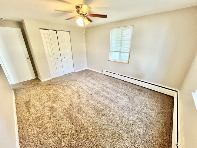 Experience comfort in this airy and well-lit bedroom, perfect for relaxation. - The Kimberly Apartments