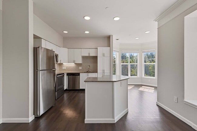 Modern kitchen design with sleek finishes and dark wood flooring - Reflections by Windsor
