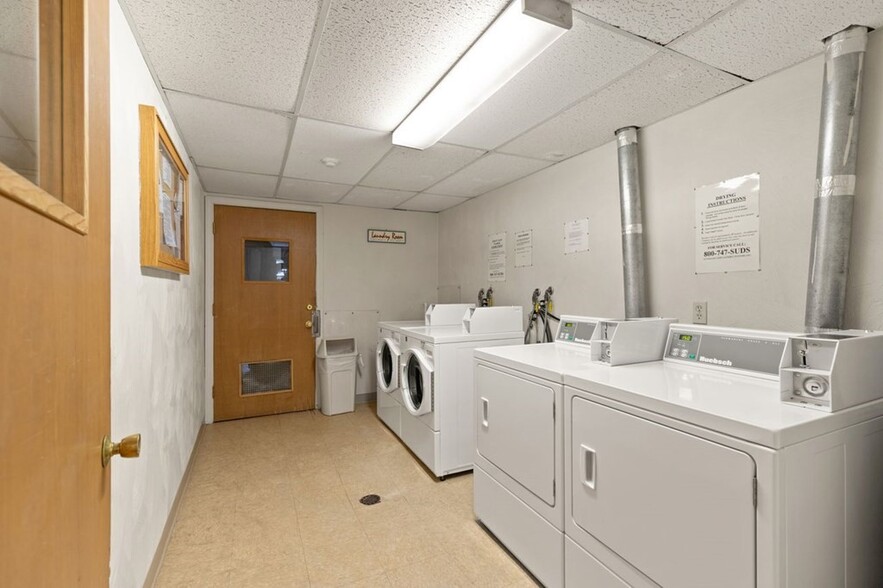 Coin operated laundry machines in the common area - 9 Kenmar Dr