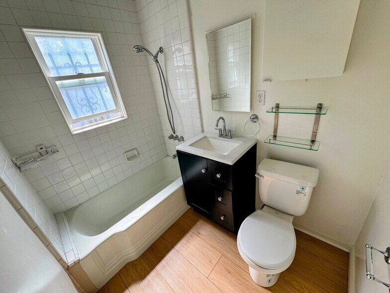 Bathroom with brand new vanity. Mirror AND cabinet provide additional shelving storage. - 839 21st St