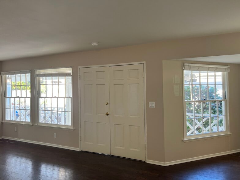 Living room with light filled windows overlooking the front porch and new landscaping - 467 S Bentley Ave