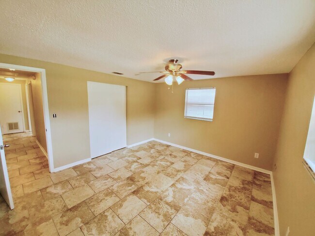 Building Photo - Three bedroom one and a half bathroom house with large yard space