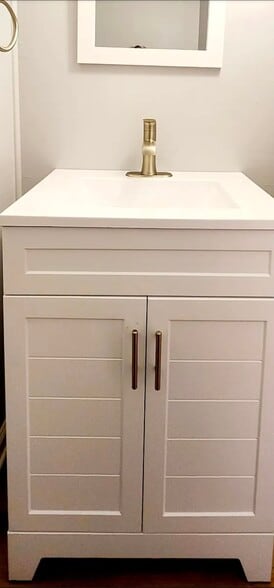 A sleek vanity with clean lines, brushed-gold faucet, and modern hardware adds a fresh contemporary - 21 Richmond Sq