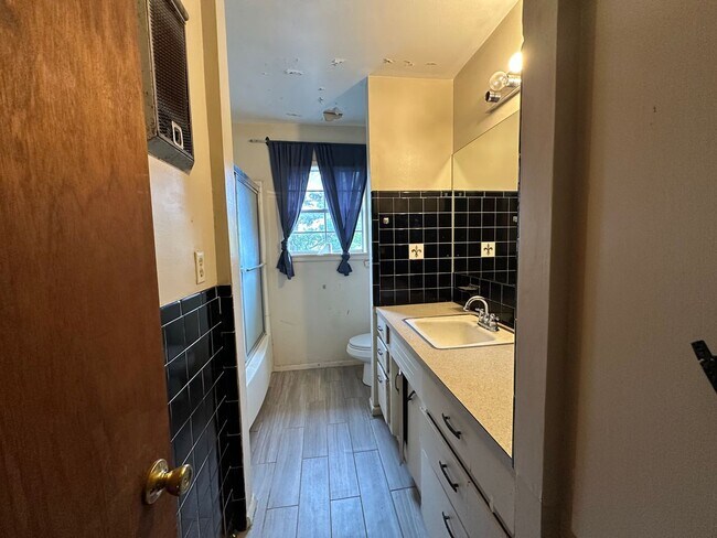 Building Photo - Available July 1st***Welcome to this charming 4-bedroom, 2-bathroom home located in the heart of ...