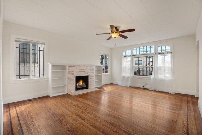 Large windows illuminate the space with the original floors of ornate in-lay wood. Built in units he - 2108 E 23rd St