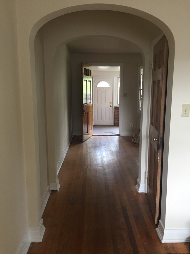 Archway connecting living room and dining room with door to basement with washer and dryer - 836 20th St S