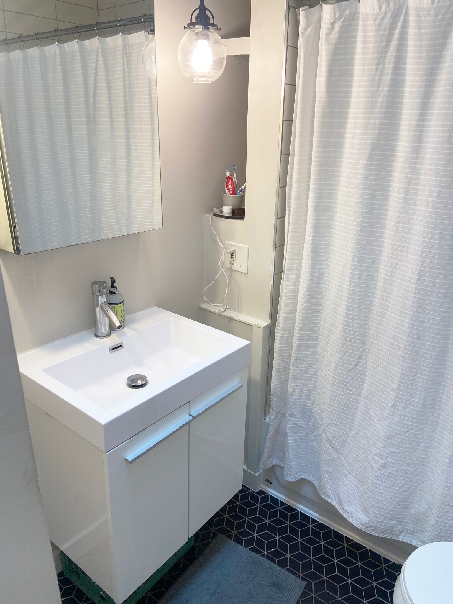 modern vanity. beautiful tiles. cool rejuvenation light fixtures and storage alcoves. check. - 5124 NE 35th Pl