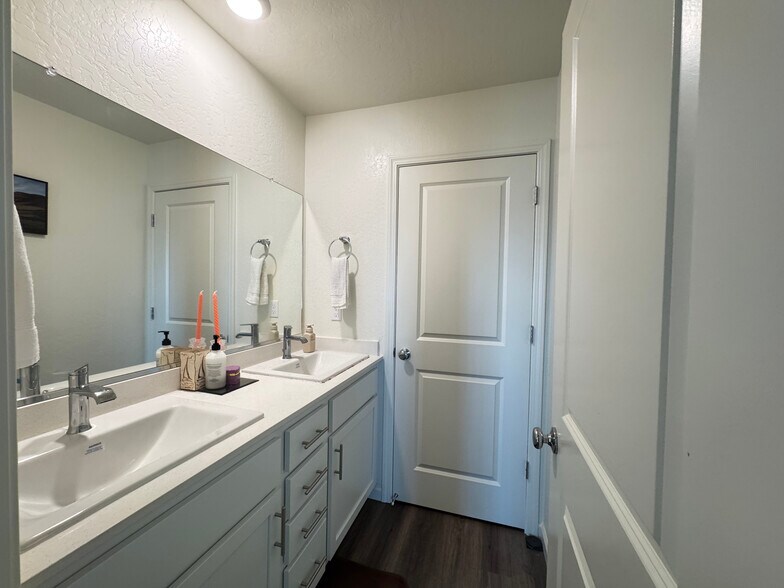 Double vanities, quartz countertops, and modern fixturesshared by tenants - 719 Irma Dr