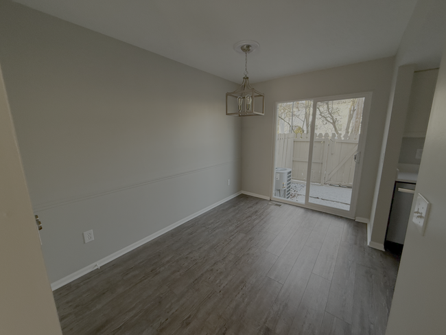 Bright dining area with a sliding door leading to a private fenced patio - 7778 Willowcove Ct