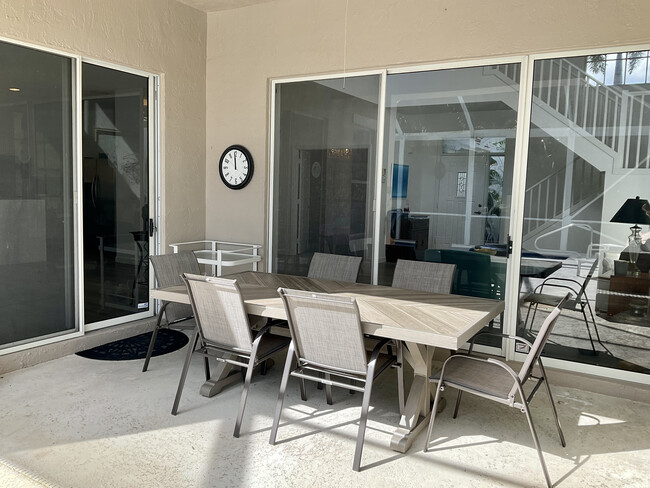 Outdoor covered dining area. - 8208 Heritage Club Dr