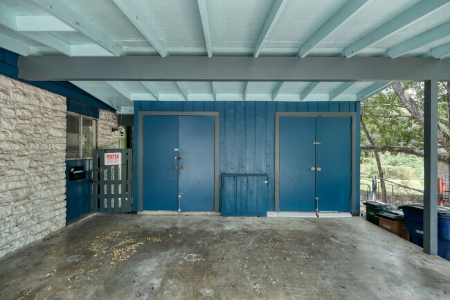 covered shared car port with laundry behind double doors - 1606 Valleyridge Dr