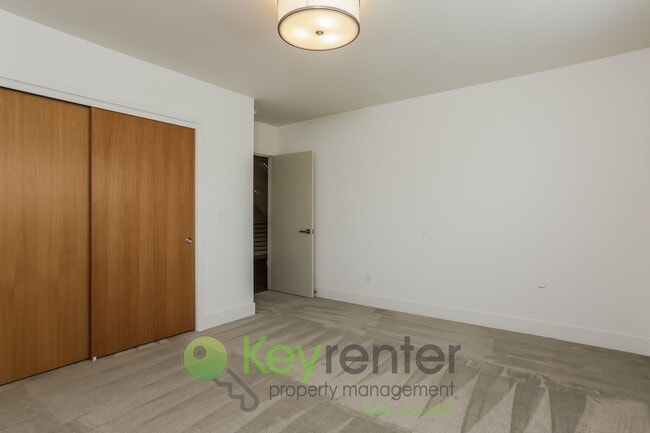 Building Photo - Spacious Living with Balconies, Deck, and Private Yard