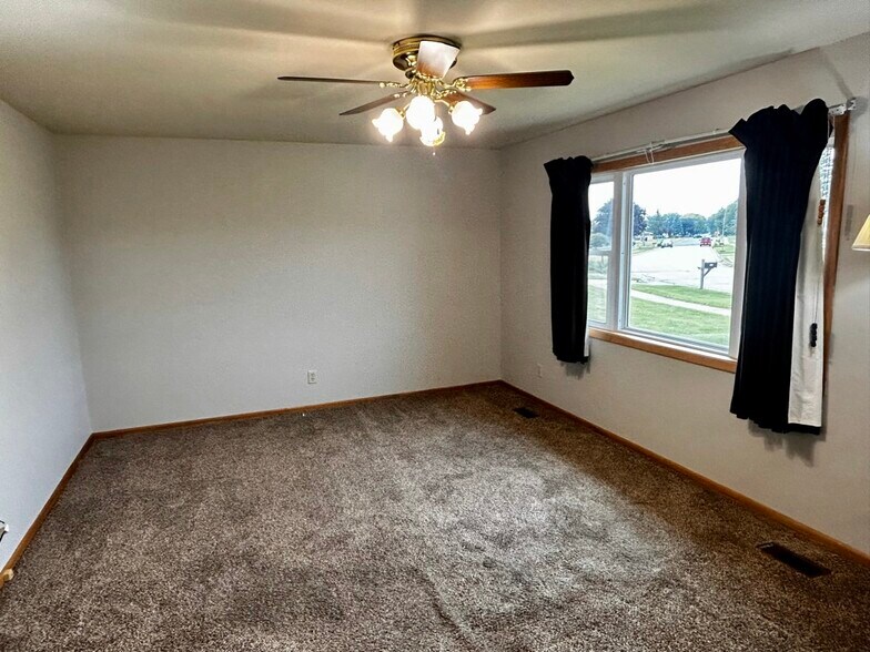 Living room with large window - 694 Tilson St N
