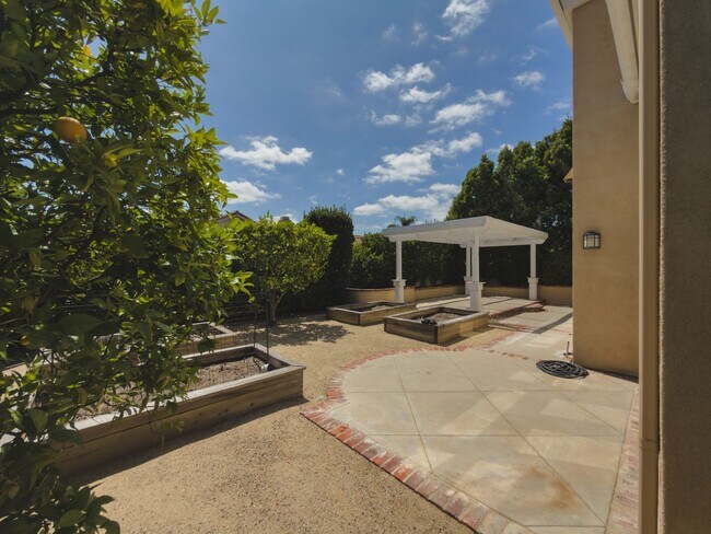 Building Photo - Elegant Mediterranean Living with Private Pergola Garden & Resort Amenities