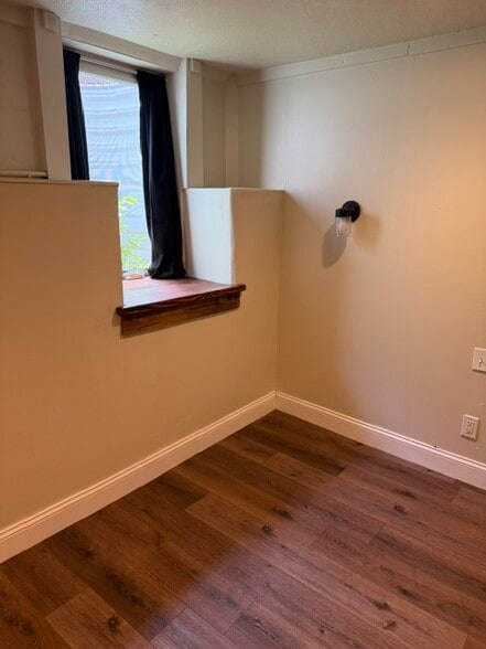 Bedroom 1-Egress window, bedside sconce with switch, reclaimed wood window sill - 2261 Newark st