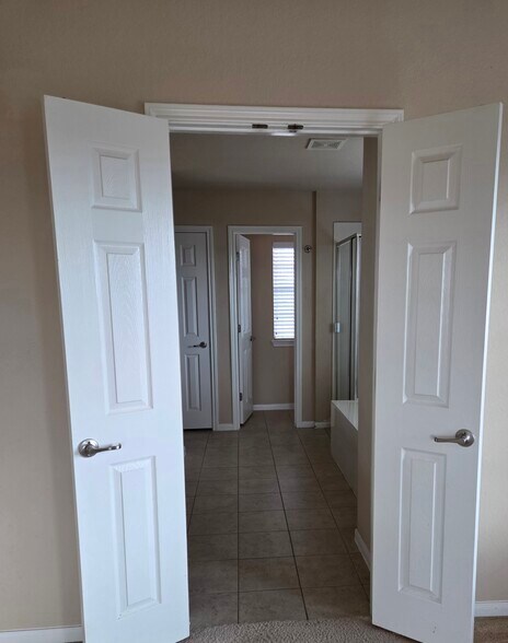 Primary bedroom entry into bath - 18204 Kermit Ct