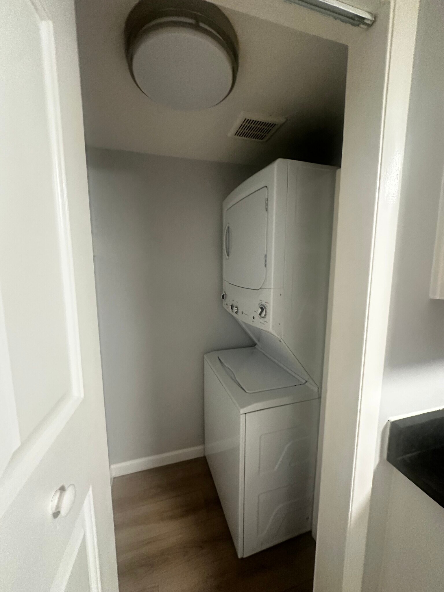 Stacked washer and dryer just off the kitchen. - 12170 Huron St