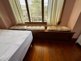 Window to front of house, window seat, hinged storage beneath cushions + curtains + mini blinds. - 2615 Parker St