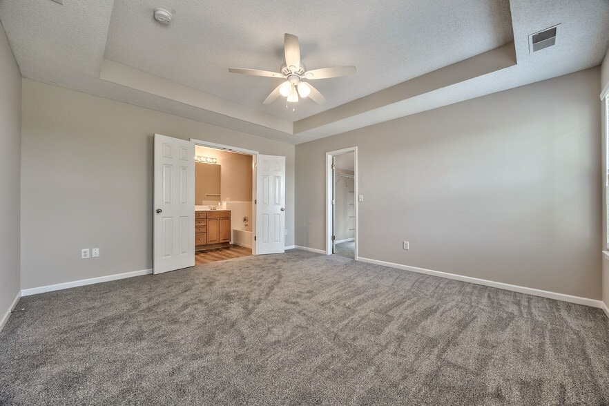 Primary bedroom with double doors to bath - 22810 West 71st Terrace
