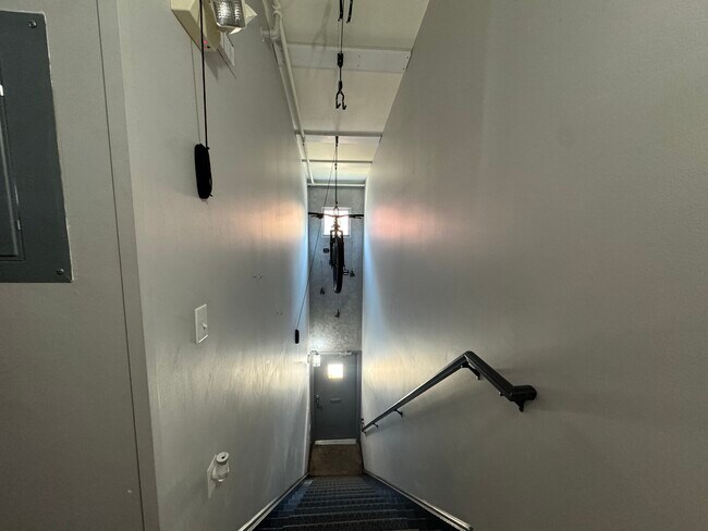 Stairwell from ground floor to second floor with hanging bike storage. - 1 Steele St