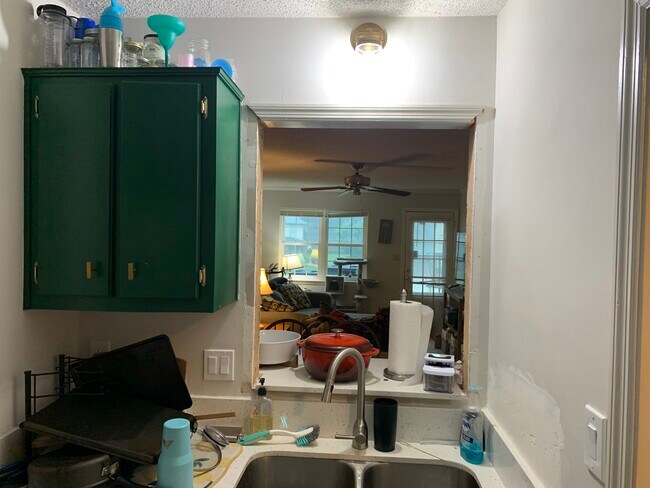Sink, Dishwasher, and Living room. Taken from Kitchen. Window will be reframed prior to move-in. - 2165 S Milledge Ave