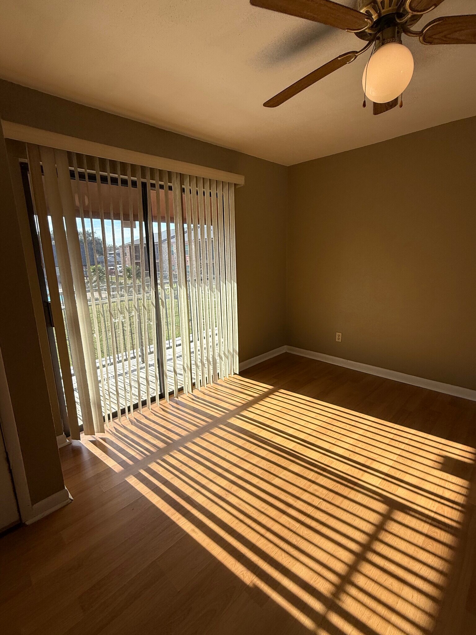 Living Room w/ a lot of light and wood flooring - 904 University Oaks Blvd