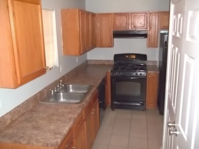 Building Photo - Freshly painted and new flooring in this 4 Bedroom 2 and Half Bath home. Covered front porch with...