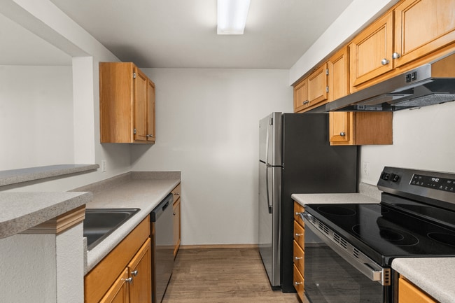 A functional kitchen designed for convenience and everyday cooking. - Villas at Lawrence