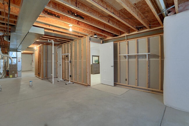 The spacious unfinished area includes the laundry room and offers endless possibilities for use. - 5512 Sonnet Hts