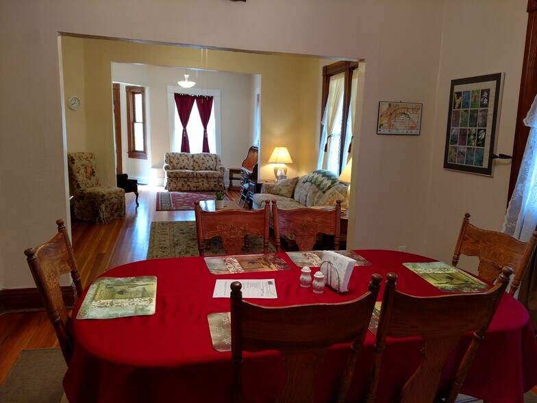 View of living spaces from kitchen toward front door (furnishings not included with rental) - 607 Harrison Ave