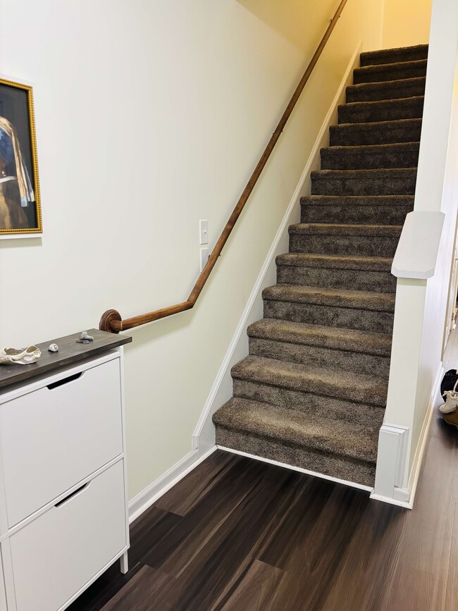 The stairs leading to the second floor is right by the door. - 105 Lincoln Place Cir