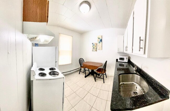 Kitchen with microwave, stove with vent, refrigerator - 1140 Ash St