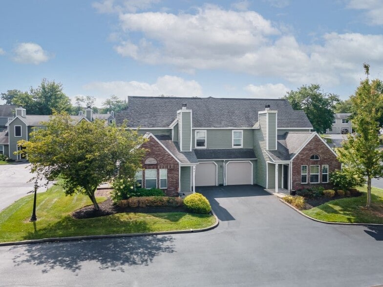 Enjoy the peaceful drive into Windridge, with tree-lined views and beautifully landscaped grounds. - Windridge Townhomes