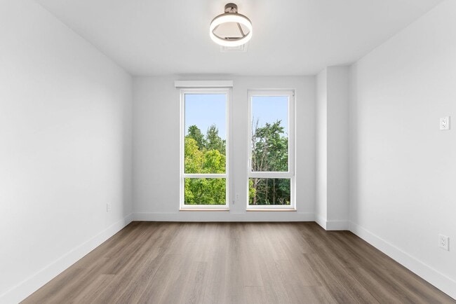 Building Photo - 2 Bedroom Corner-Unit with Wooded Balcony ...