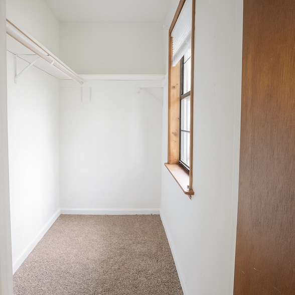 Walk-in closet with natural light, fresh tones, and generous storage space. - 2313 Salem West Dr