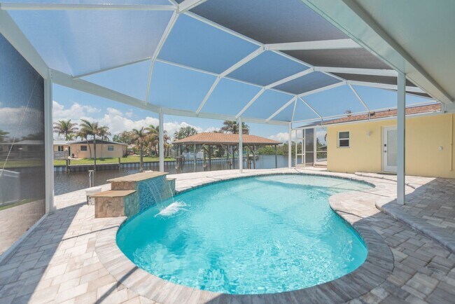 Building Photo - Live the ultimate Space Coast waterfront lifestyle at this stunning beachside canal home in Satel...