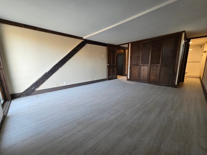 Spacious master bed with beam detail - 60 W Winter St