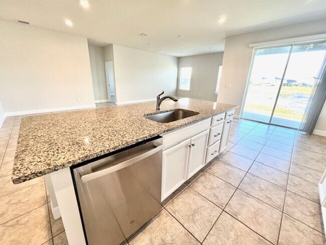 Building Photo - Open concept home offering four bedrooms, three baths, a two car garage and open lanai.