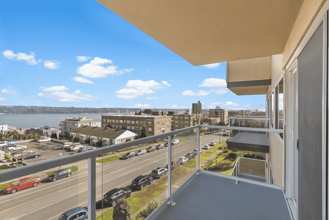 Experience serene mornings on your private balcony with breathtaking views of the horizon. - Vista Terrace Apartments